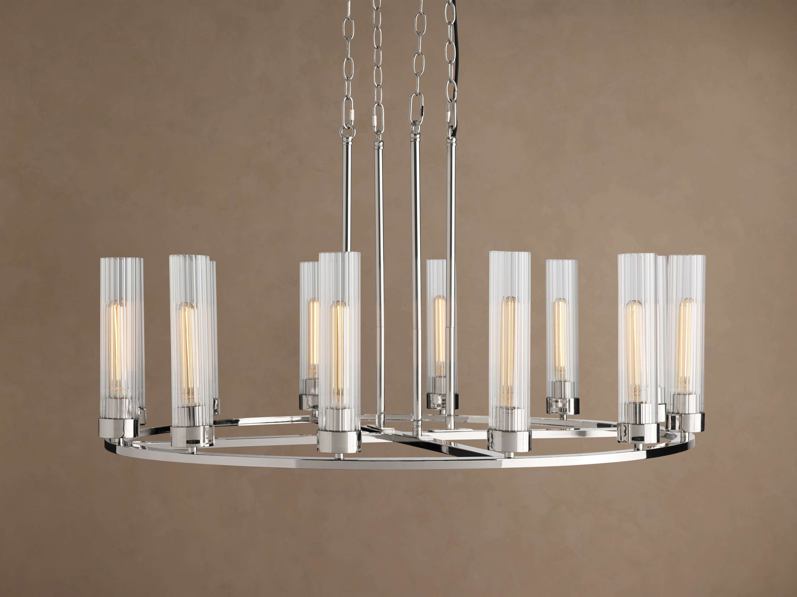 Andreas Round Chandelier, polished nickel finish, round frame, 12 glowing bulbs in clear fluted glass shades, suspended by chains.