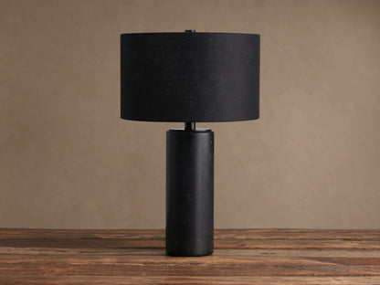 Brixton Table Lamp: Close-up of its cylindrical black marble base with white veining and a thin black metal stem.
