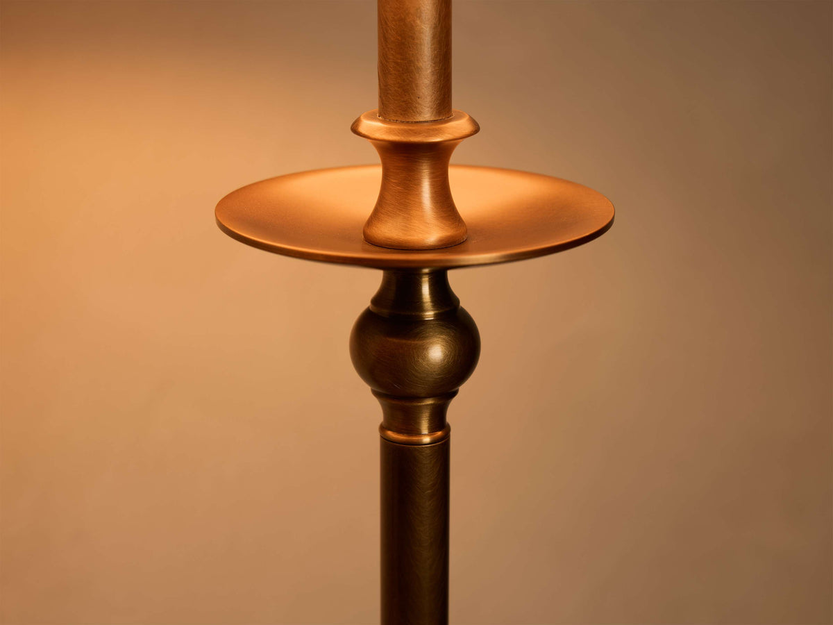 Close-up of the bronze-finished iron base of the Winslow Table Lamp, detailing a sculpted column and decorative disk.
