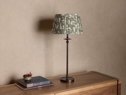 Front view of a Bronze Winslow Table Lamp, featuring a green and white floral pleated fabric shade.