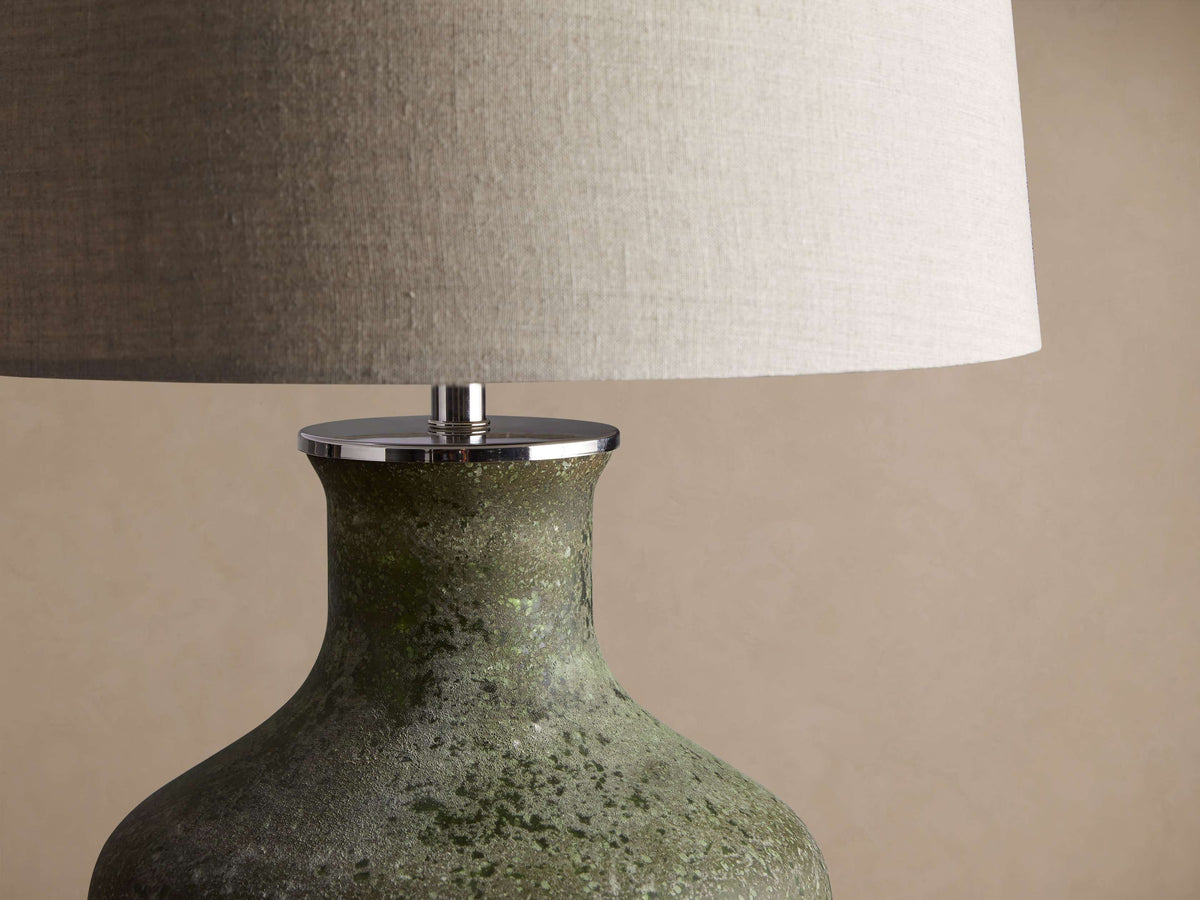 Close-up of Galena Table Lamp, featuring a textured, sand-blasted green glass base and a light linen shade.